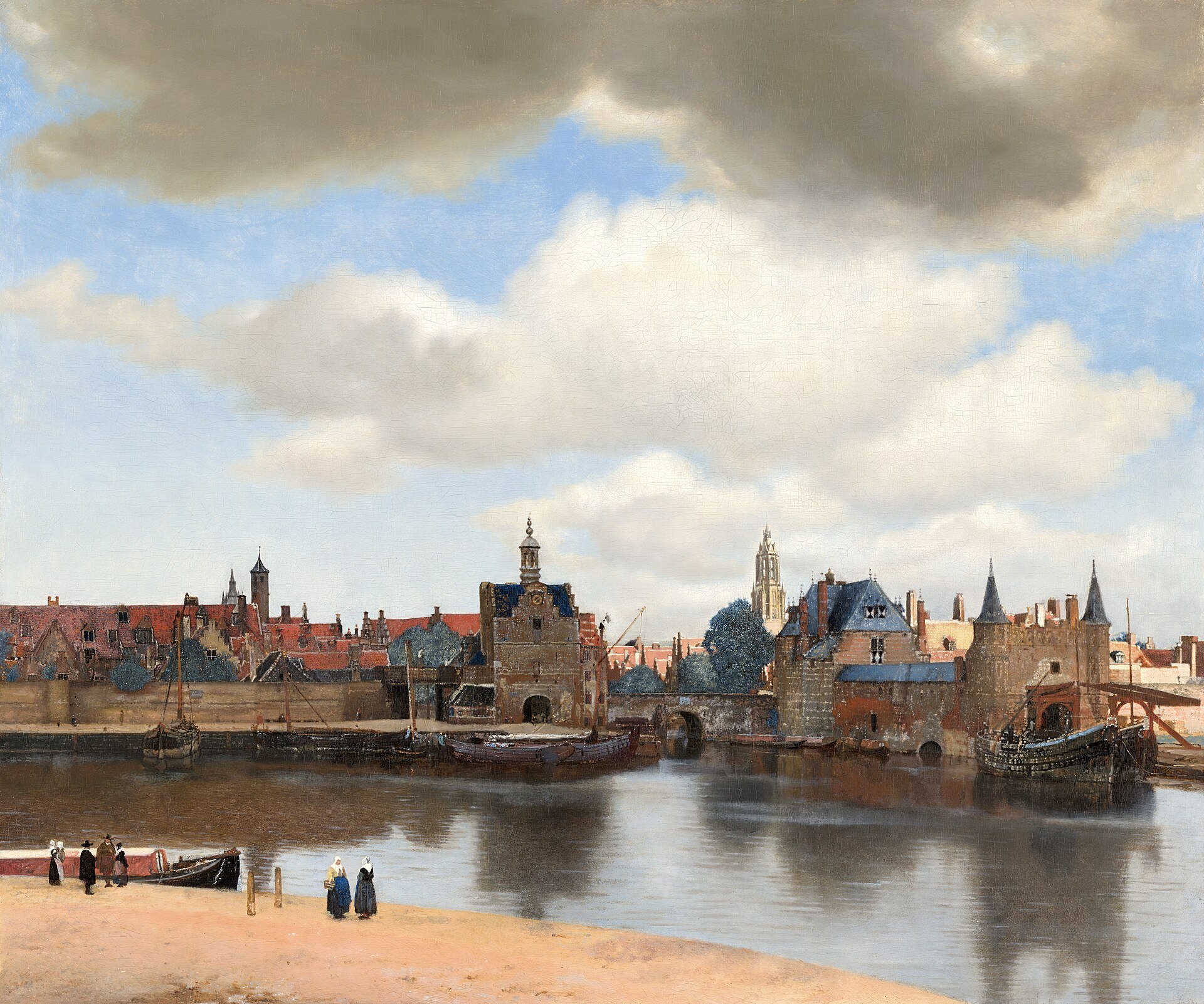 Vermeer's painting of Delft seen across the water: a long row of brick walls, gates and roofs under a big cloudy sky, with one church tower lit by the sun.